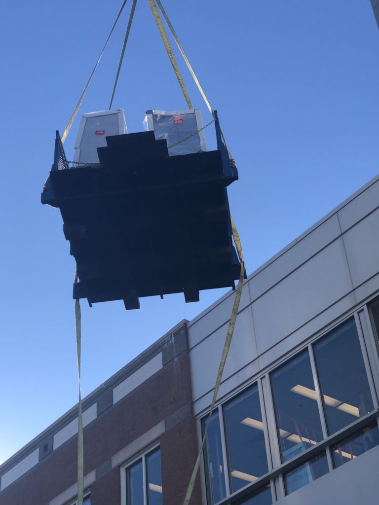 Lab equipment being moved by a crane